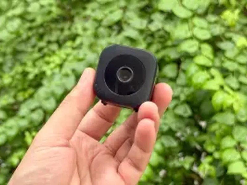 GuardHouse camera held in the palm of a hand outdoors