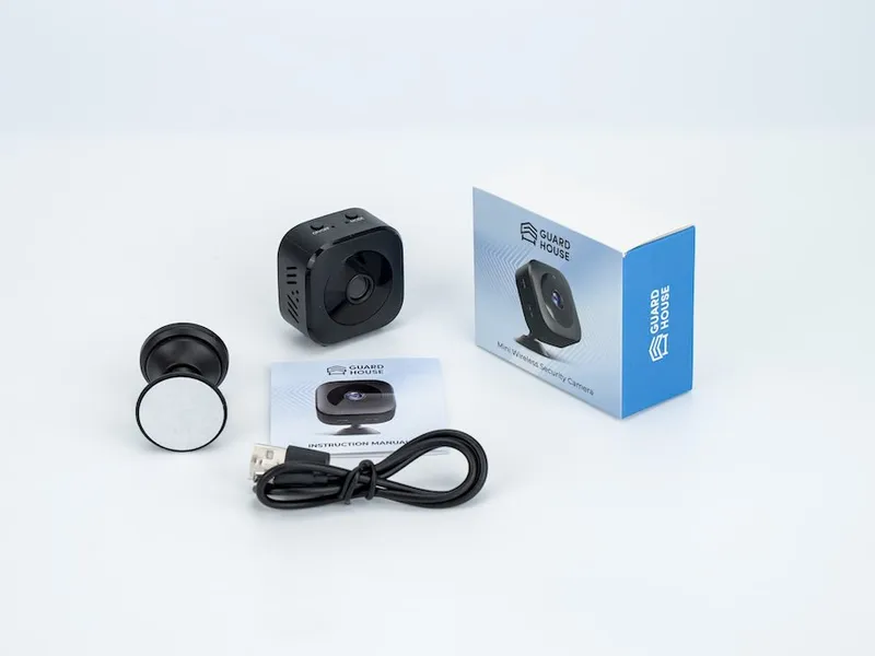 GuardHouse camera with its magnetic base, mount, charging cable and box