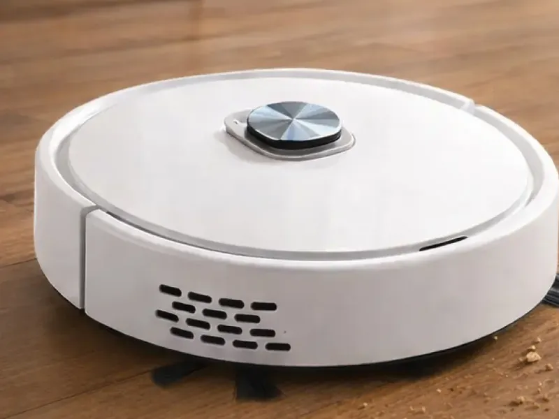 White RoboVac Pro robot vacuum on a wood floor